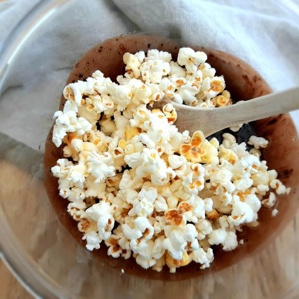 Popcorn and melted chocolate in a bowl